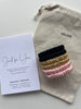 Silk scrunchies in black gold pink on pouch with Just for You card